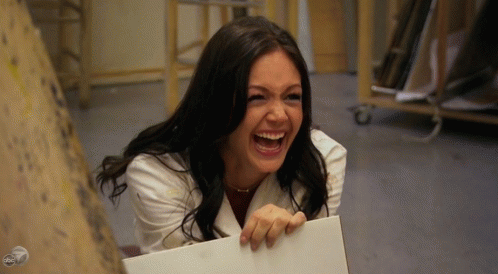 Woman In White Coat Laughing Holding Paper GIF