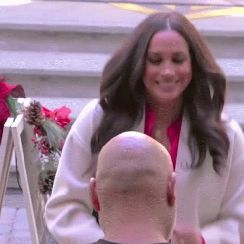 Woman in White Coat Next to Bald Man