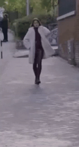 Woman in White Coat Walking