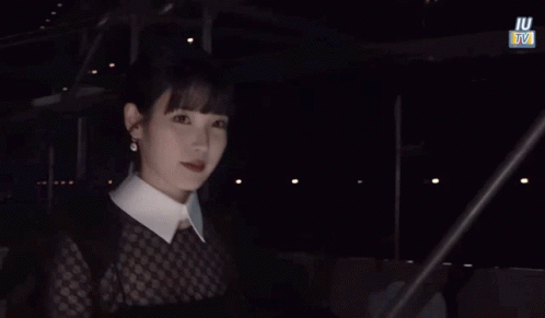 Woman in White Collared Shirt with IU TV Sign