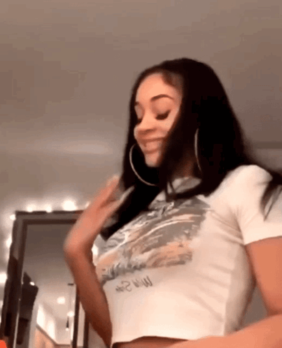 Woman in White Crop Top and Hoop Earrings