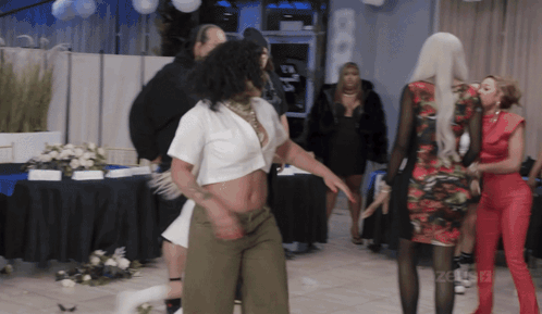 Woman In White Crop Top Dancing In Front Of Celebrity Sign GIF