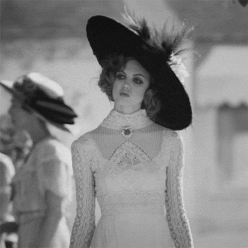 Woman in White Dress and Black Hat