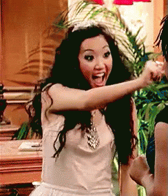 Woman In White Dress And Tiara Pointing At Another Woman GIF