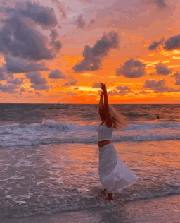 Woman in White Dress Arms Up on Beach