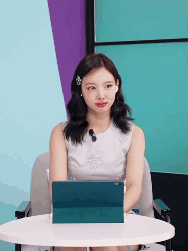 Woman In White Dress At Table With Tablet GIF