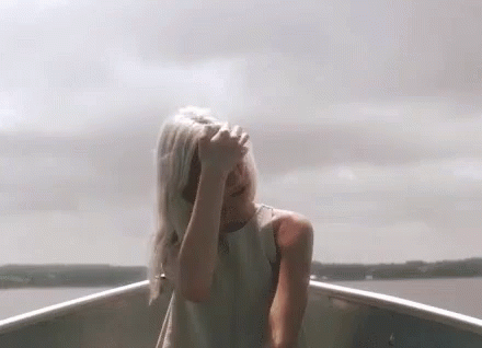 Woman In White Dress Covering Face In Boat GIF