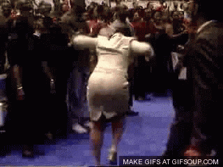 Woman in White Dress Dancing in Front of Crowd