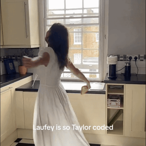 Woman in White Dress Dancing in Kitchen Laufey Is So Taylor Coded