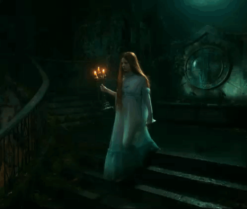 Woman in White Dress Holding Candle