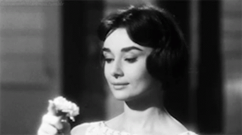 Woman in White Dress Holding Flower Black and White