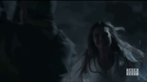 Woman in White Dress in Dark Room Show Case