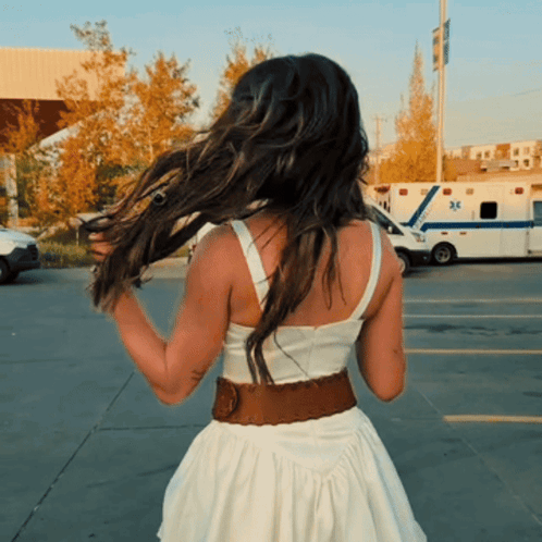 Woman in White Dress in Front of Ambulance 32