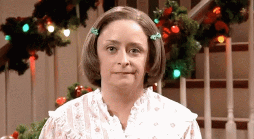 Woman In White Dress In Front Of Christmas Lights GIF