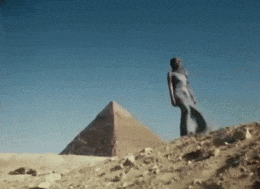 Woman in White Dress in Front of Pyramid