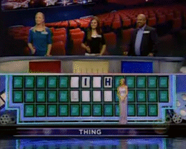 Woman in White Dress in Front of Wheel of Fortune Saying Thing