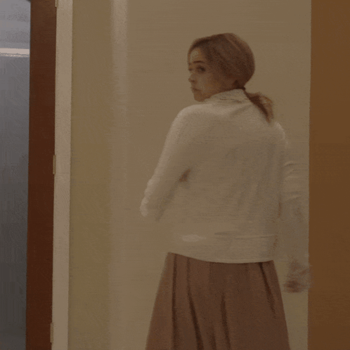 Woman in White Dress in Frosted Glass Doorway