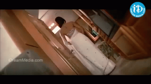 Woman in White Dress Near Dream Media Logo