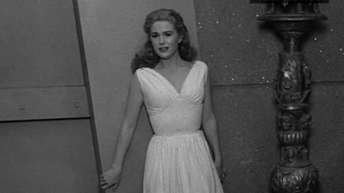 Woman in White Dress Next to Pole Black and White