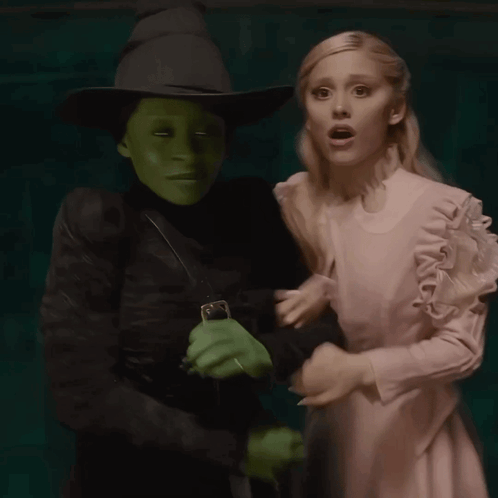 Woman in White Dress Next to Witch
