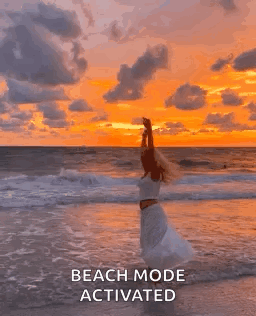 Woman in White Dress on Beach at Sunset