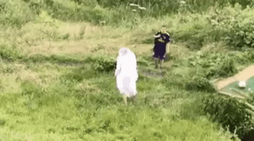 Woman In White Dress Running Through Grassy Field GIF