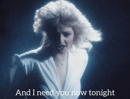 Woman in White Dress Singing And I Need You Now Tonight