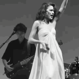 Woman In White Dress Singing While Man Plays Guitar GIF