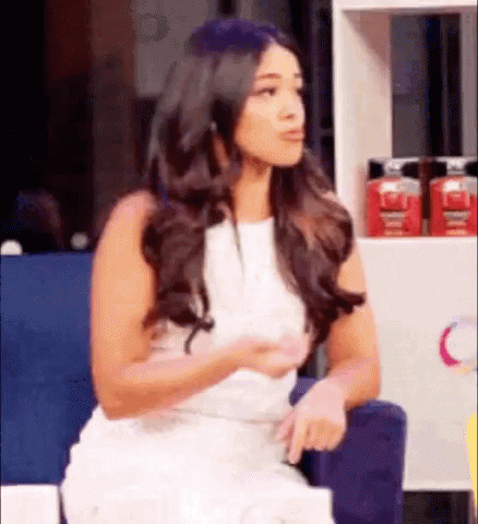 Woman In White Dress Sitting In Chair Talking GIF