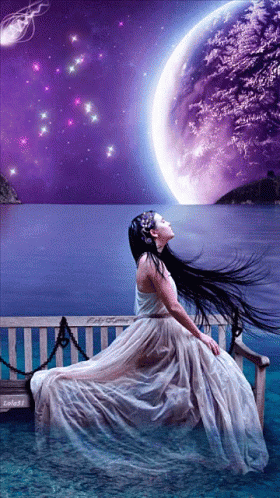 Woman In White Dress Sitting On Bench Overlooking Ocean GIF