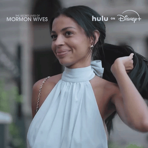 Woman in White Dress Smiling for Secret Lives of Mormon Wives on Hulu