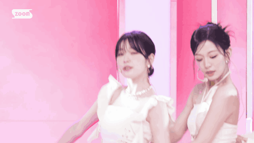 Woman in White Dress Smiling Next to Two Women