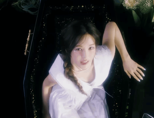 Woman in White Dress Standing in Black Coffin