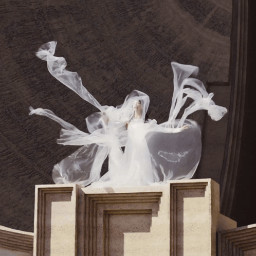 Woman in White Dress Standing on Pillar