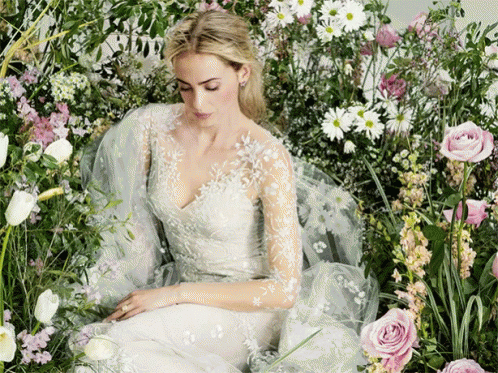 Woman In White Dress Surrounded By Flowers GIF