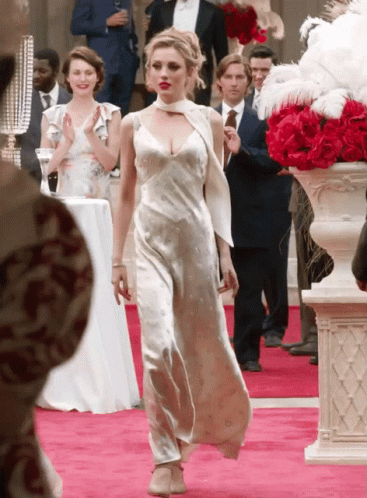 Woman in White Dress Walking Down Red Carpet