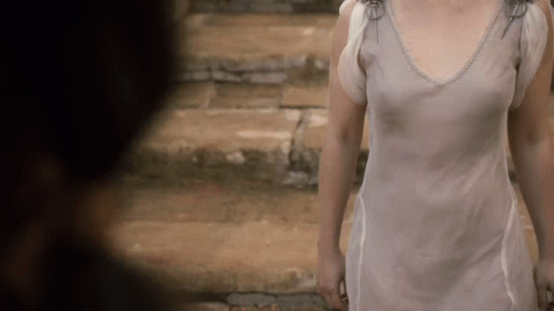 Woman in White Dress Walking Down Stone Steps