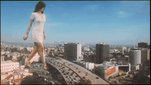 Woman In White Dress Walking Over Highway In City GIF