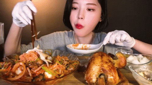 Woman in White Gloves Eating With Spoon