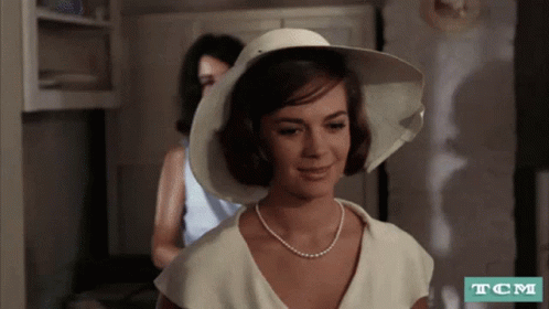 Woman In White Hat And Pearl Necklace GIF