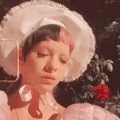 Woman in White Hat and Pink Dress With Red Rose