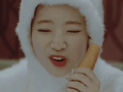 Woman in White Hat Eating Carrot Stick
