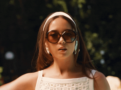 Woman in White Headband and Sunglasses Looking at Camera
