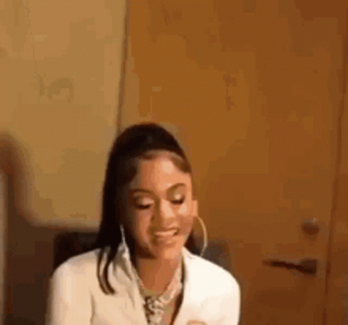 Woman in White Jacket and Hoop Earrings Smiling