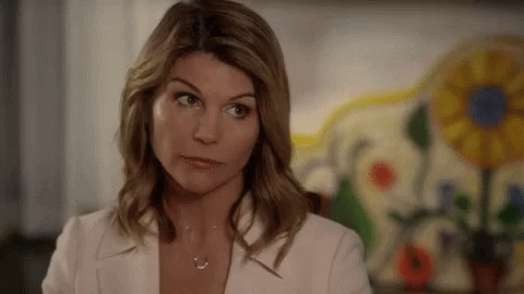 Woman In White Jacket And Necklace Looking Away GIF