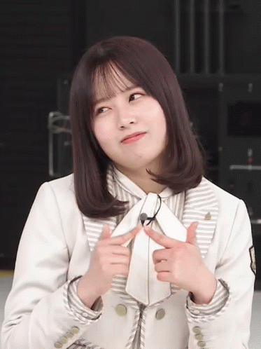 Woman in White Jacket and Tie Making Face