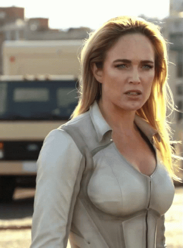 Woman In White Jacket In Front Of Van GIF