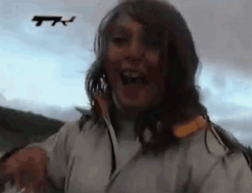 Woman In White Jacket Laughing At Drone GIF