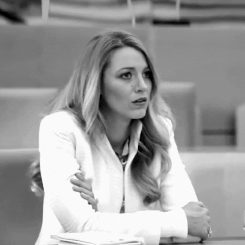 Woman in White Jacket Sitting Crossed Arms