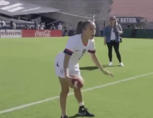 Woman in White Jersey Number 2 Throwing Soccer Ball